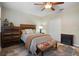 Cozy bedroom with wood-look floors, comfortable bed and decorative accents at 104 W Lake Victoria Cir, Deland, FL 32724