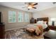 Serene bedroom showcasing window shutters, ceiling fan, and a rustic wood bed frame at 104 W Lake Victoria Cir, Deland, FL 32724