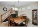 Elegant dining room with wooden table, chairs, staircase, and decorative lighting at 104 W Lake Victoria Cir, Deland, FL 32724