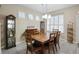 Charming dining room with a wooden table, seating for six, and modern chandelier at 104 W Lake Victoria Cir, Deland, FL 32724