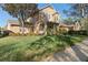 Beautiful two-story home with a lush green lawn and mature trees at 104 W Lake Victoria Cir, Deland, FL 32724