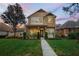 Charming two-story home features a welcoming front porch and beautifully landscaped lawn at 104 W Lake Victoria Cir, Deland, FL 32724