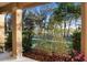 Inviting front porch with scenic views of mature trees and a serene lake at 104 W Lake Victoria Cir, Deland, FL 32724