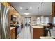 Open kitchen with breakfast bar, seamlessly connecting to outdoor patio at 104 W Lake Victoria Cir, Deland, FL 32724