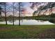 Picturesque view of a calm lake reflecting a colorful sunset sky at 104 W Lake Victoria Cir, Deland, FL 32724