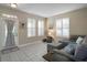 Inviting living room showcasing natural light, tile flooring, and a comfortable sectional sofa at 104 W Lake Victoria Cir, Deland, FL 32724