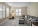 Cozy living room featuring neutral tones, tile flooring, and comfortable seating at 104 W Lake Victoria Cir, Deland, FL 32724
