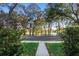 Scenic street view featuring a tranquil lake bordered by lush trees at 104 W Lake Victoria Cir, Deland, FL 32724