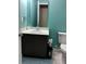 Bathroom with a toilet, sink with cabinets, and a mirror at 112 Grande Lake Dr, Daytona Beach, FL 32124