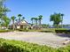 Community clubhouse with a pool, parking, and palm trees set against a clear blue sky at 112 Grande Lake Dr, Daytona Beach, FL 32124