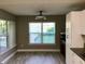 Bright dining area featuring wood floors, large windows and white cabinetry at 112 Grande Lake Dr, Daytona Beach, FL 32124