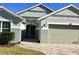 Charming home exterior showcasing neutral tones, a well-maintained lawn, and a paved entryway at 112 Grande Lake Dr, Daytona Beach, FL 32124