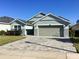 Charming single-story home featuring a well-manicured lawn and a two car garage at 112 Grande Lake Dr, Daytona Beach, FL 32124