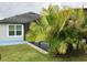 Exterior view of the home showcasing a lush lawn and landscaping at 112 Grande Lake Dr, Daytona Beach, FL 32124