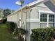 Home exterior with manicured shrubbery and a neutral paint scheme at 112 Grande Lake Dr, Daytona Beach, FL 32124