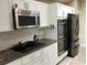 Bright kitchen features white cabinets, stainless steel appliances and granite countertops at 112 Grande Lake Dr, Daytona Beach, FL 32124