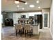 Open kitchen with island, stone countertops, stainless appliances, and white cabinets at 112 Grande Lake Dr, Daytona Beach, FL 32124