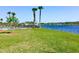 Scenic view of the community lake and a fountain with palm trees and green lawn at 112 Grande Lake Dr, Daytona Beach, FL 32124