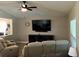 Relaxing living room featuring comfortable seating, tv and ceiling fan at 112 Grande Lake Dr, Daytona Beach, FL 32124