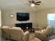 Comfortable living room with recliner seating, tv and tile flooring at 112 Grande Lake Dr, Daytona Beach, FL 32124