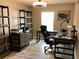 Home office featuring wood floors, shelves, and stylish desk at 112 Grande Lake Dr, Daytona Beach, FL 32124