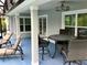 Covered patio with comfortable seating and ceiling fan, perfect for outdoor relaxation and entertaining at 112 Grande Lake Dr, Daytona Beach, FL 32124