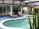 Relaxing screened in pool area, with outdoor furniture and patio at 112 Grande Lake Dr, Daytona Beach, FL 32124