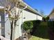 Landscaped side yard with meticulous hedging at 112 Grande Lake Dr, Daytona Beach, FL 32124