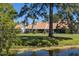 Peaceful backyard view of home, mature trees and a pond; serene natural surroundings at 120 Black Duck Cir, Daytona Beach, FL 32119