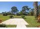 Large backyard with well-maintained lawn and tiled patio; serene and perfect for outdoor relaxation at 120 Black Duck Cir, Daytona Beach, FL 32119