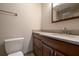 Bathroom featuring granite countertop, wood cabinets and updated fixtures at 120 Black Duck Cir, Daytona Beach, FL 32119