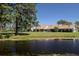 Scenic exterior view of the home overlooking a pond, surrounded by mature trees at 120 Black Duck Cir, Daytona Beach, FL 32119