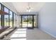 Light-filled sun room with tile floor and large windows overlooking backyard at 120 Black Duck Cir, Daytona Beach, FL 32119