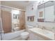 Bathroom features a shower-tub combination with sliding doors, white vanity, toilet, and tiled walls at 120 Hibiscus Woods Ct # 14D, Deltona, FL 32725
