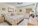 Bedroom features a ceiling fan, neutral walls, a floral comforter, and tile floors at 120 Hibiscus Woods Ct # 14D, Deltona, FL 32725