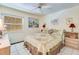 Bedroom features a ceiling fan, neutral walls, a patchwork quilt, and tile floors at 120 Hibiscus Woods Ct # 14D, Deltona, FL 32725