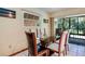 Dining area featuring a glass table, six chairs, and a view of the outdoors at 120 Hibiscus Woods Ct # 14D, Deltona, FL 32725