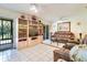 Living room with tile flooring, a ceiling fan, and a sliding glass door to the outside at 120 Hibiscus Woods Ct # 14D, Deltona, FL 32725