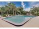 A refreshing community pool surrounded by lush tropical landscaping at 120 Hibiscus Woods Ct # 14D, Deltona, FL 32725