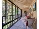 Sunroom features black framed windows providing views of the surrounding landscape at 120 Hibiscus Woods Ct # 14D, Deltona, FL 32725