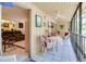 Bright sunroom with white tile flooring, wood walls, ceiling fan, and views to living room at 120 Hibiscus Woods Ct # 14D, Deltona, FL 32725