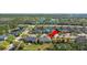 Aerial view of a well-maintained residential home with a landscaped yard, surrounded by lush greenery at 1205 Draycott St, Ormond Beach, FL 32174