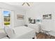Cozy bedroom with wood floors, white walls, and a view from the window at 1205 Draycott St, Ormond Beach, FL 32174