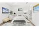 Well-lit primary bedroom with a tray ceiling, comfortable decor, and an ensuite bathroom at 1205 Draycott St, Ormond Beach, FL 32174