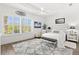 Inviting bedroom with large windows, tray ceiling, modern decor, and plush rug at 1205 Draycott St, Ormond Beach, FL 32174