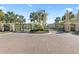 Grand community entrance with a central roundabout and lush landscaping, showcasing pride of ownership and meticulous maintenance at 1205 Draycott St, Ormond Beach, FL 32174