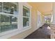 Charming exterior with large windows and tan siding, complemented by a brick-paved walkway, and neutral trim at 1205 Draycott St, Ormond Beach, FL 32174