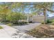 Well-maintained home exterior with a paved driveway, two-car garage, and verdant landscaping, offering a welcoming appeal at 1205 Draycott St, Ormond Beach, FL 32174