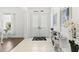 Bright foyer features tiled floors, modern console table, and double-door entry at 1205 Draycott St, Ormond Beach, FL 32174