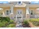 Elegant home entrance featuring stately white pillars with stone accents and double doors, enhancing curb appeal at 1205 Draycott St, Ormond Beach, FL 32174